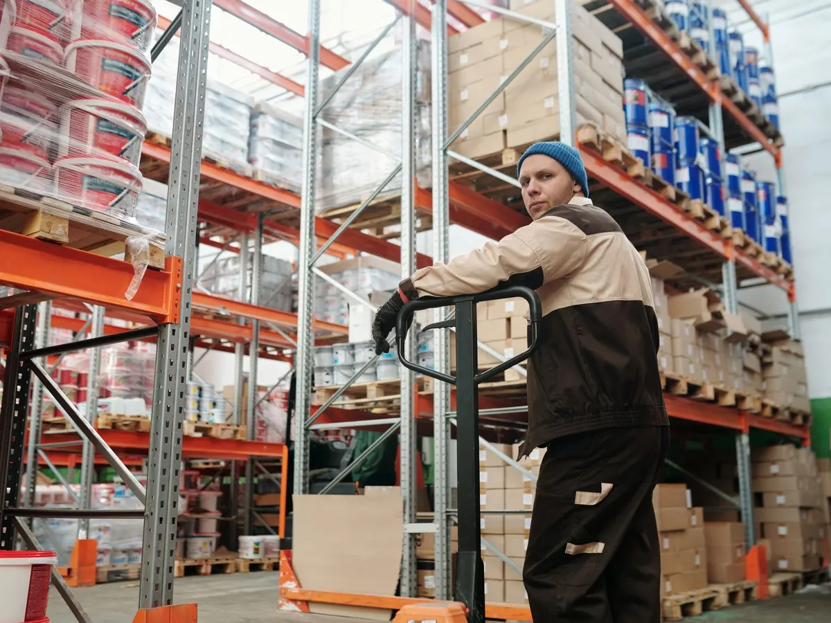 Lithium electric pallet truck, cash and carry trolley and platform scale on a white warehouse floor